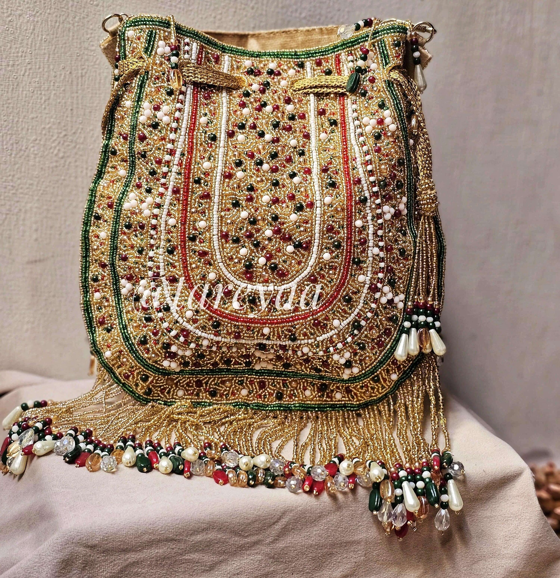 Handmade Qavali potli bag with intricate beadwork, golden cutdana, and detailed embellishments for a luxurious look.
