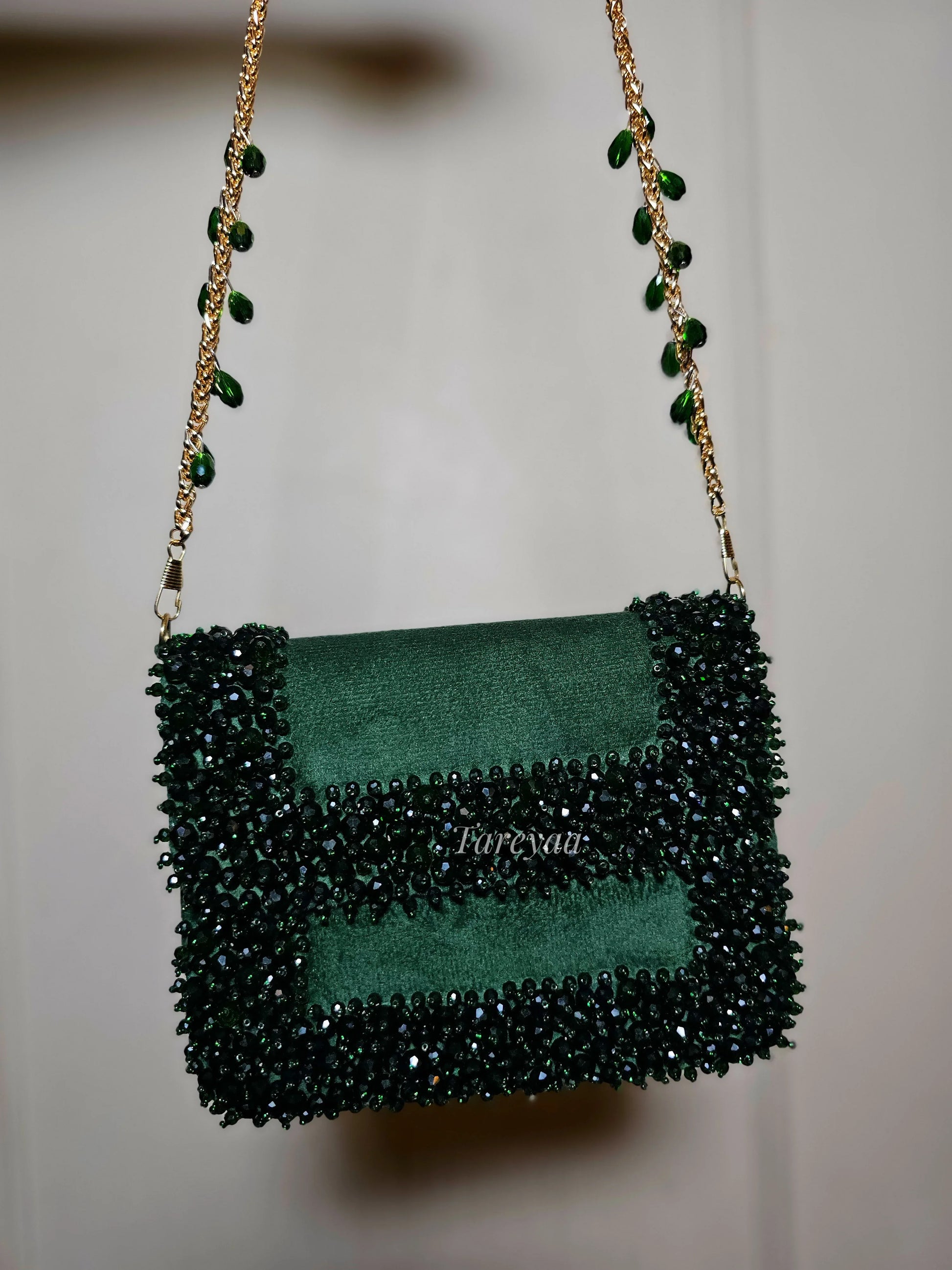Narma bottle green velvet clutch bag with stone and crystal embellishments and long sling by Tareyaa — Indian bridal bag